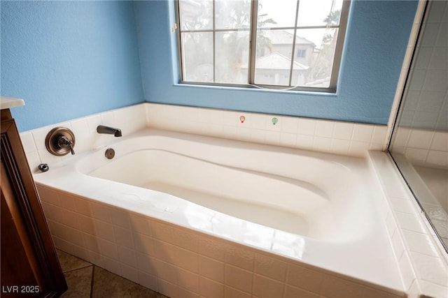 bathroom featuring a bath, tile patterned flooring, and vanity