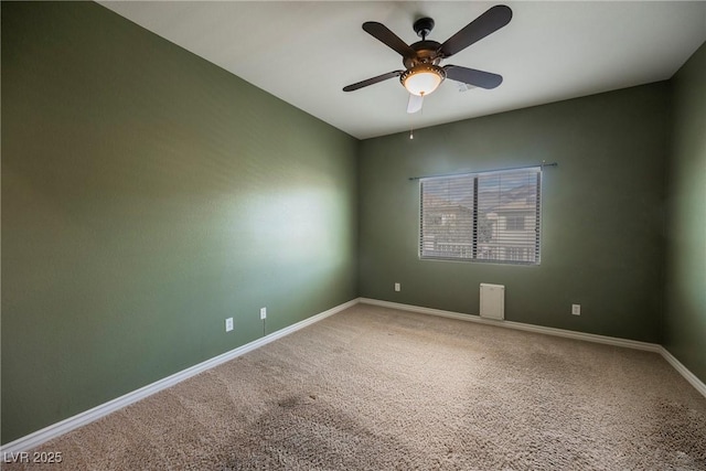 carpeted empty room with baseboards and ceiling fan