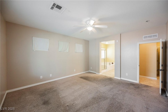 unfurnished bedroom featuring visible vents, baseboards, carpet, and ensuite bathroom