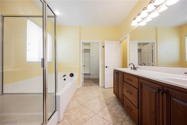 full bathroom featuring a sink, a stall shower, a bath, and double vanity