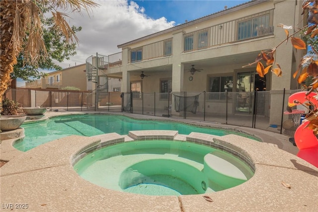 view of swimming pool featuring a patio, a pool with connected hot tub, a ceiling fan, and fence