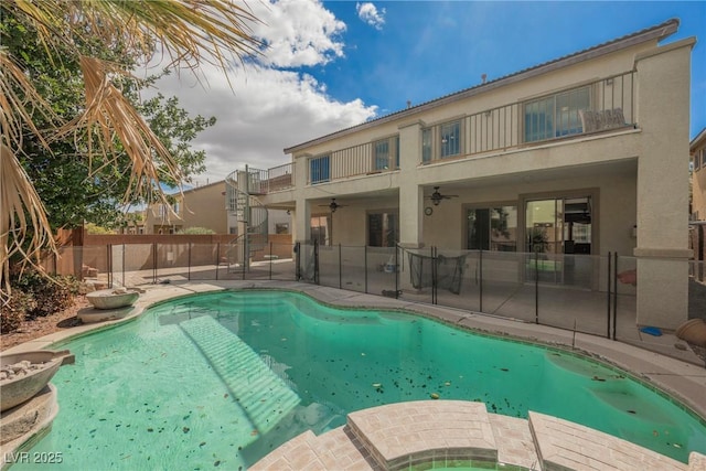 view of pool featuring a patio, a ceiling fan, fence, a fenced in pool, and an in ground hot tub