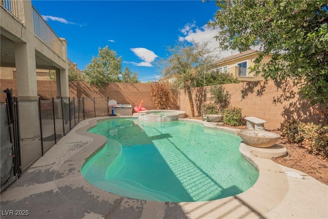 view of swimming pool with a pool with connected hot tub and a fenced backyard