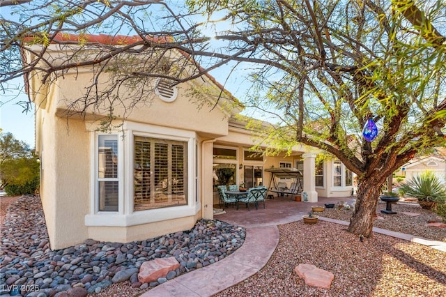 10548 Findlay Ave, Las Vegas, NV 89134 - rear view of property featuring stucco siding and a patio area