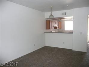 unfurnished living room with visible vents