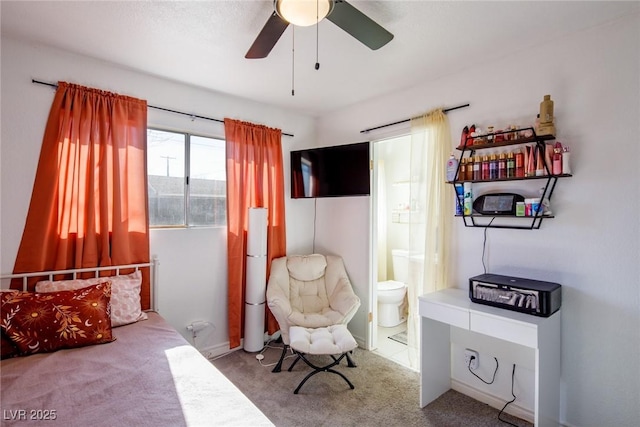 carpeted bedroom with a ceiling fan and ensuite bathroom