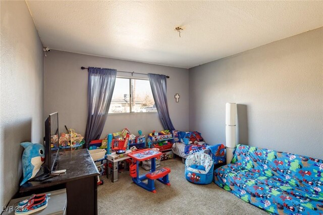 rec room featuring carpet flooring and a textured ceiling