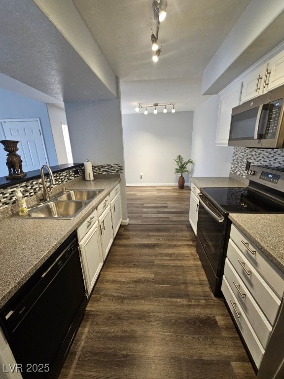 kitchen with tasteful backsplash, stainless steel microwave, black dishwasher, electric range, and a sink