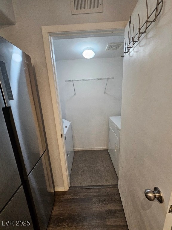 laundry area featuring visible vents, baseboards, dark wood-style flooring, and laundry area