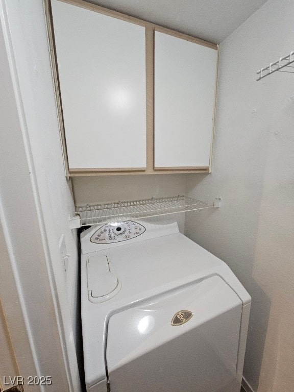 washroom with washer / clothes dryer and cabinet space