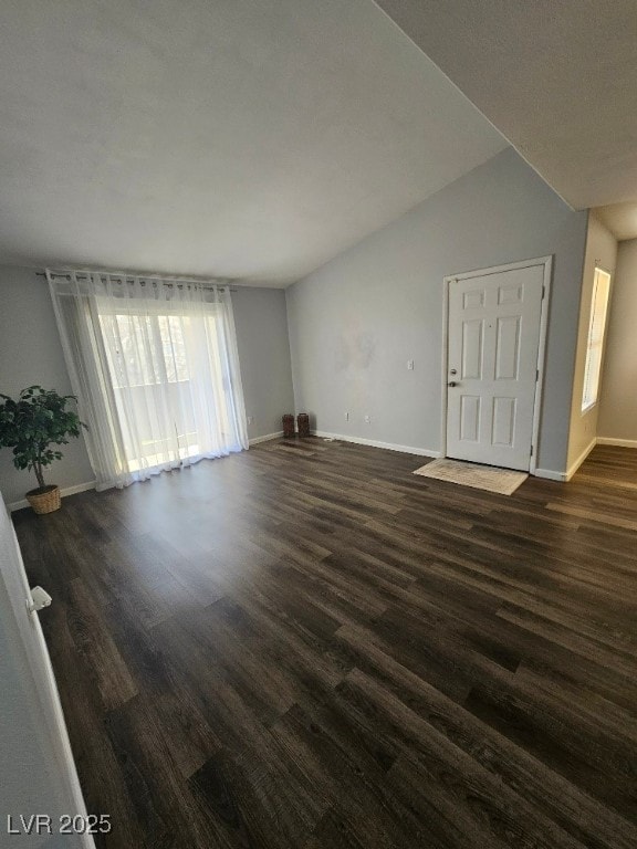 empty room featuring dark wood-style floors and baseboards