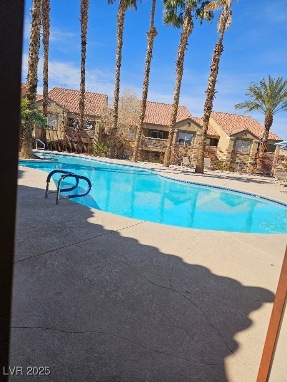 view of pool with a fenced in pool, a patio area, and fence