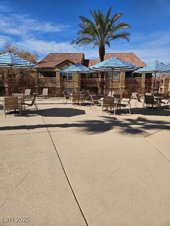 view of property's community with a patio and fence