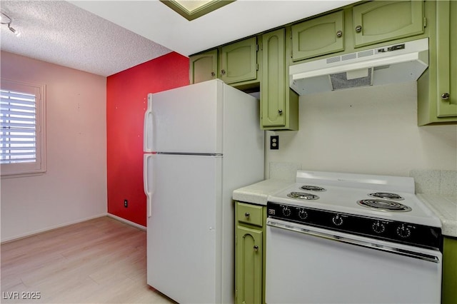 kitchen featuring under cabinet range hood, white appliances, green cabinets, and light countertops