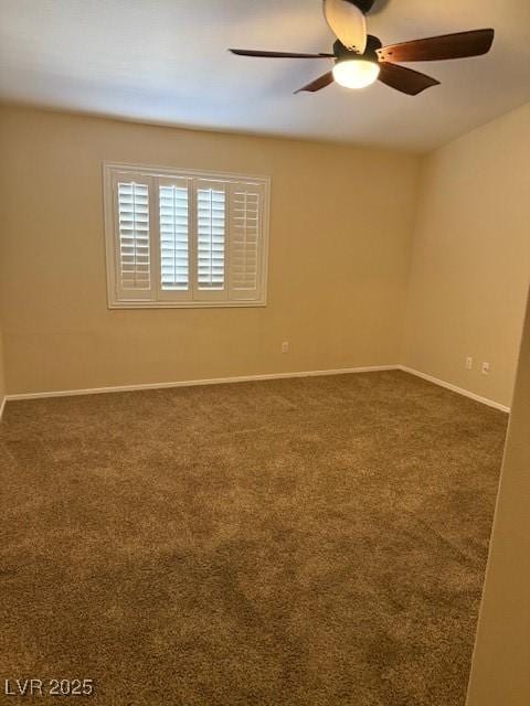 carpeted spare room with baseboards and ceiling fan