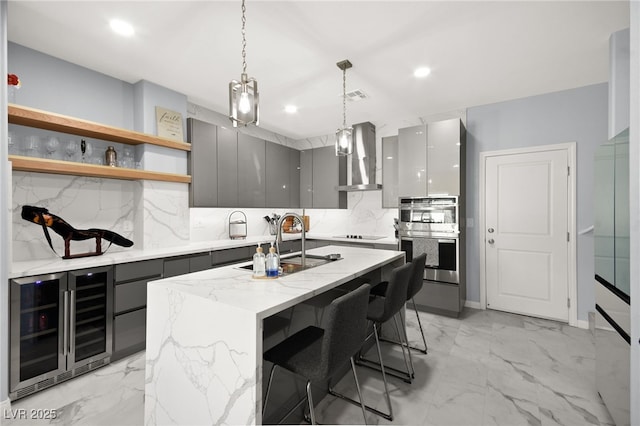 kitchen with wine cooler, gray cabinets, modern cabinets, and wall chimney range hood