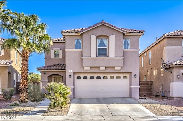 mediterranean / spanish home with concrete driveway, an attached garage, fence, and stucco siding