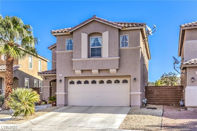 mediterranean / spanish house with stucco siding, concrete driveway, and fence