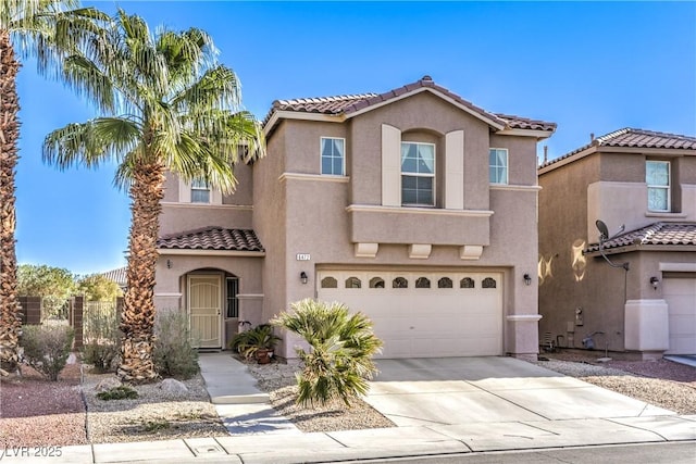 mediterranean / spanish house with an attached garage, driveway, and stucco siding