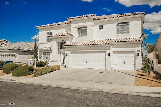 mediterranean / spanish-style house featuring stucco siding, concrete driveway, and a garage