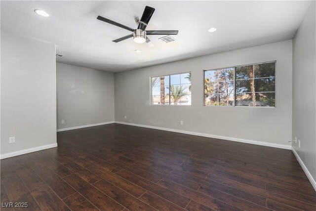 spare room featuring a ceiling fan, recessed lighting, wood finished floors, and baseboards