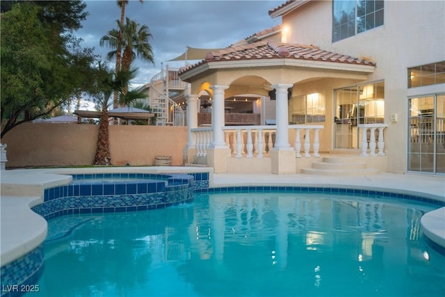 view of pool with a pool with connected hot tub