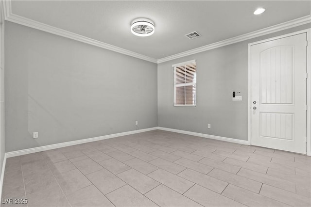 spare room with visible vents, crown molding, and baseboards