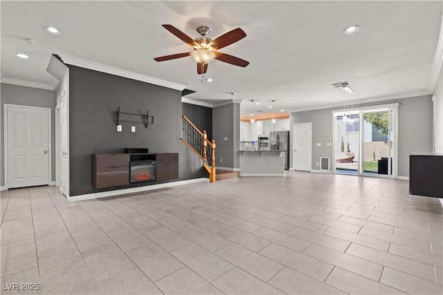 unfurnished living room featuring stairway, baseboards, and ornamental molding