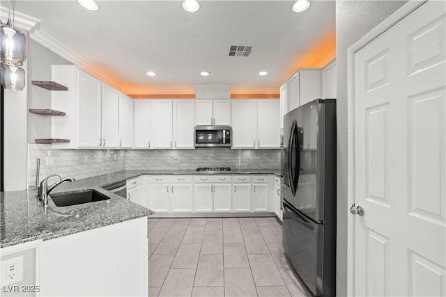 kitchen featuring visible vents, a sink, open shelves, appliances with stainless steel finishes, and white cabinets