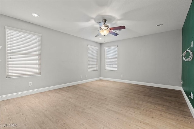 spare room with recessed lighting, baseboards, wood finished floors, and a ceiling fan