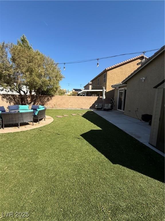 view of yard with outdoor lounge area, a patio area, and a fenced backyard