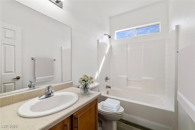 bathroom featuring vanity, toilet, and shower / washtub combination