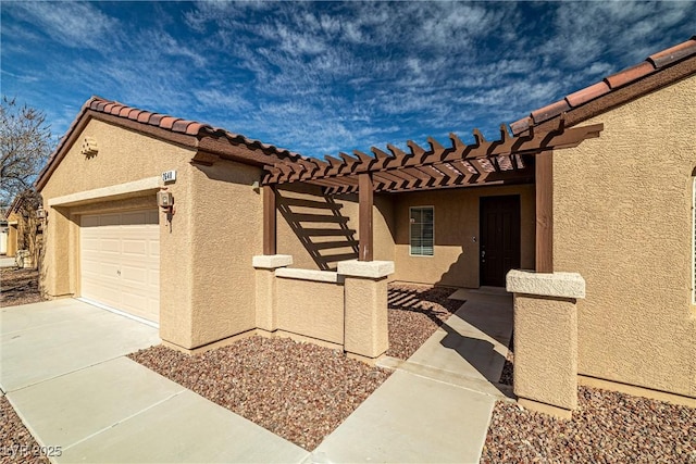 view of front of house featuring a pergola, stucco siding, concrete driveway, a garage, and a tile roof