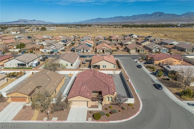 birds eye view of property with a mountain view and a residential view