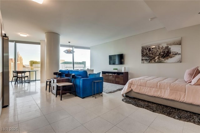 bedroom featuring a wall of windows and light tile patterned floors