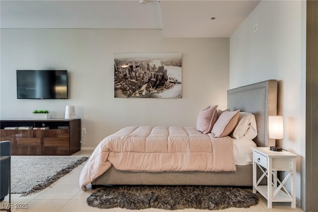 tiled bedroom featuring baseboards