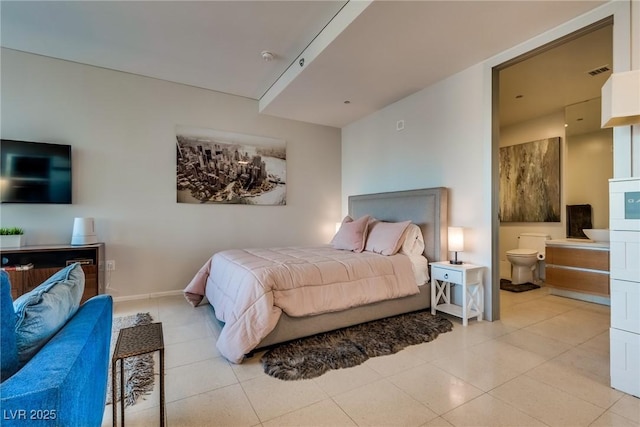 bedroom featuring light tile patterned floors, visible vents, baseboards, and ensuite bathroom