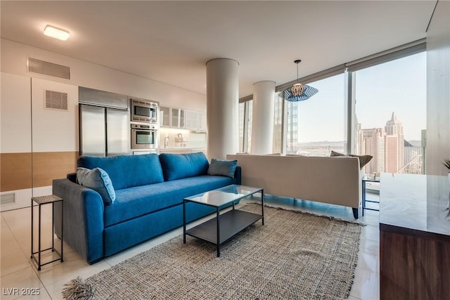 living area featuring visible vents, a view of city, and light tile patterned flooring