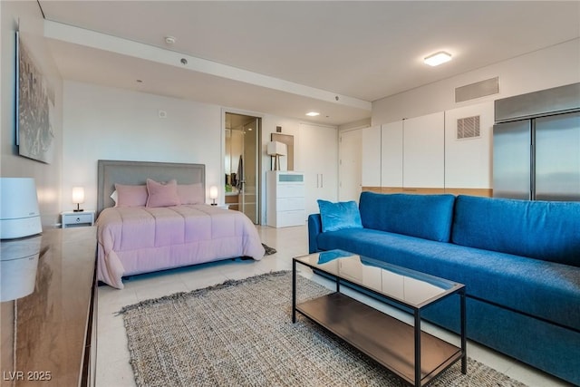 bedroom featuring light tile patterned floors and visible vents