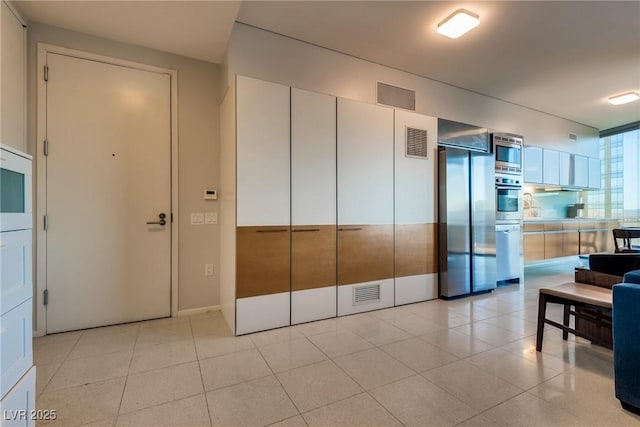 kitchen featuring light tile patterned floors, visible vents, and appliances with stainless steel finishes