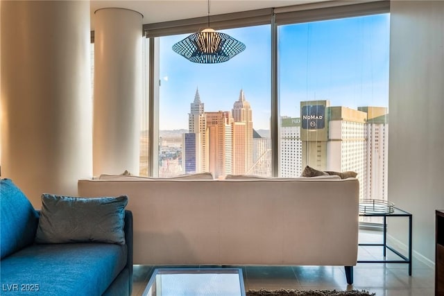 sitting room featuring a view of city and baseboards