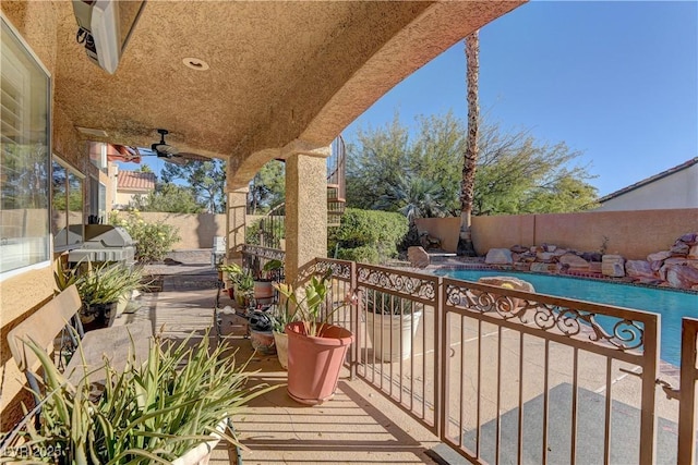 balcony with a patio and ceiling fan