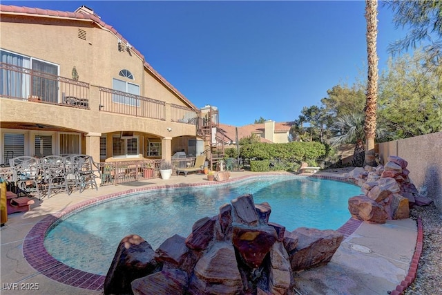 view of pool featuring a patio area, a fenced in pool, and fence