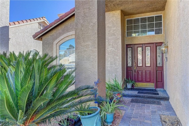 property entrance featuring stucco siding