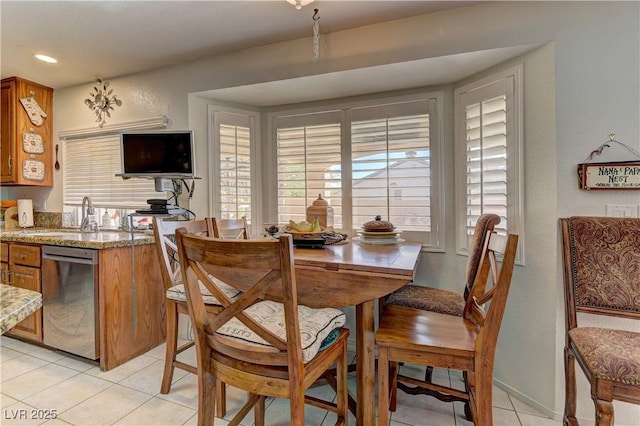 dining area featuring light tile patterned flooring, a textured wall, and recessed lighting