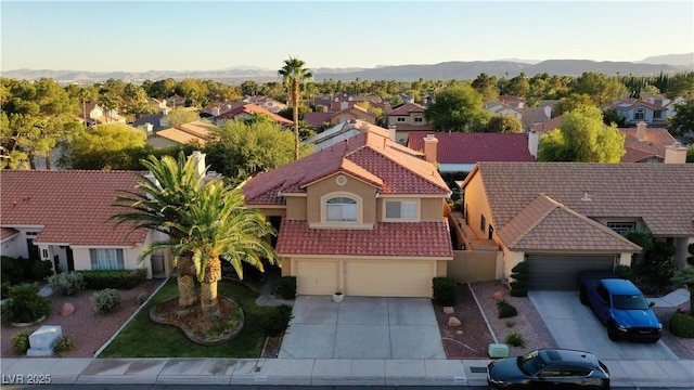 drone / aerial view featuring a residential view and a mountain view