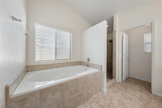 full bath featuring baseboards, a garden tub, a shower stall, and tile patterned flooring