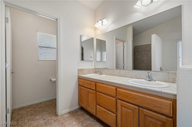 full bathroom featuring a sink, a wealth of natural light, and double vanity