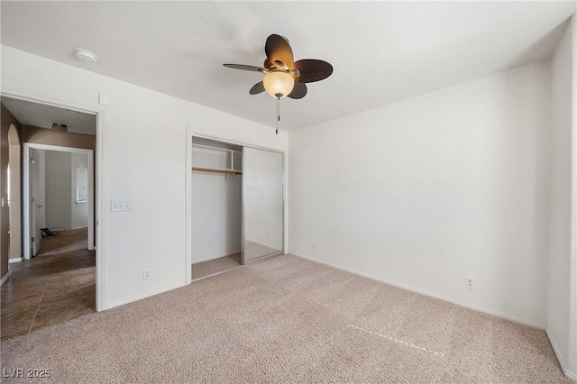 unfurnished bedroom featuring a closet, carpet, and ceiling fan