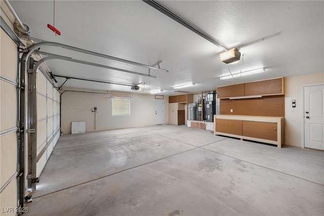 garage featuring water heater and a garage door opener